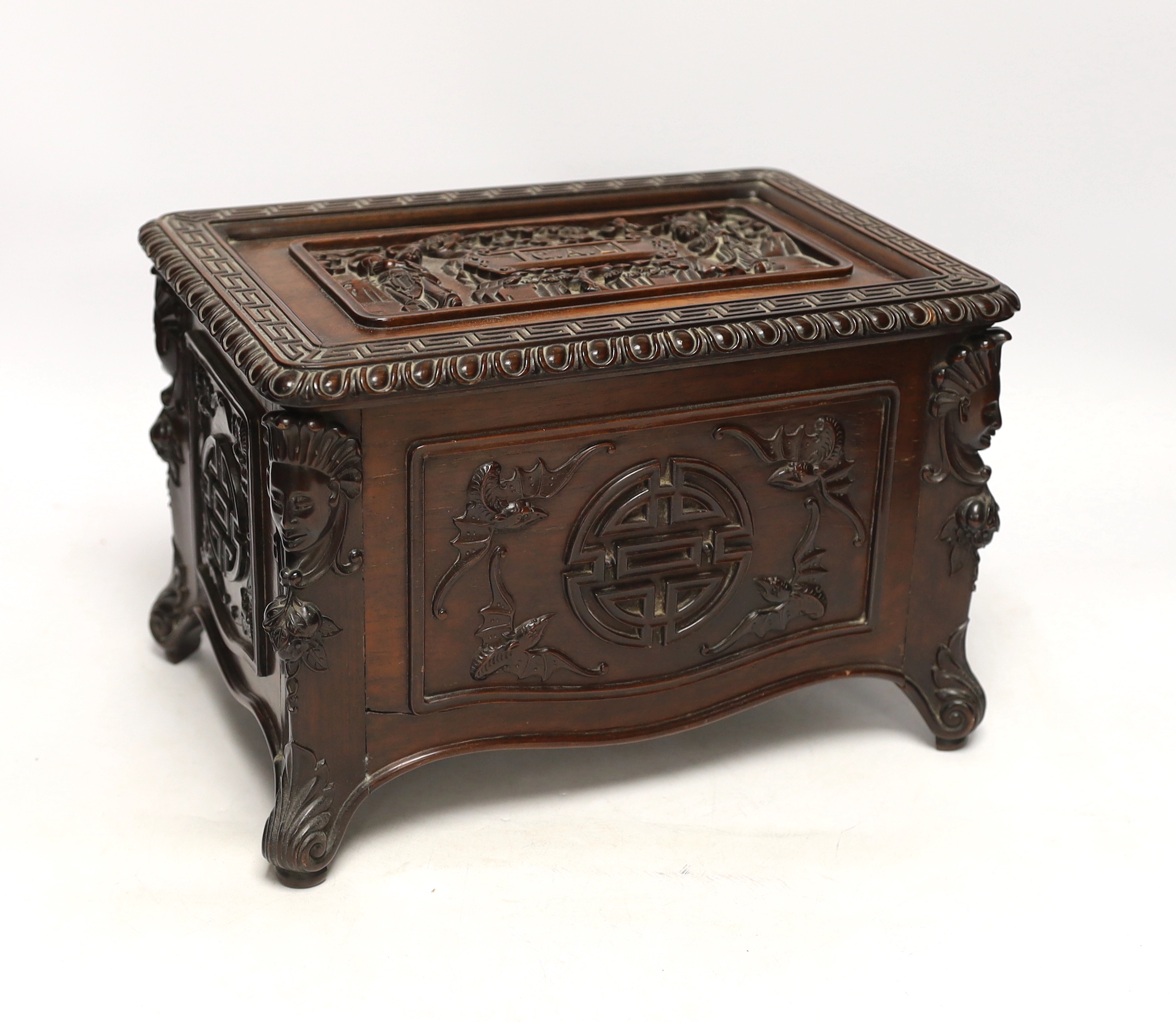 An early 20th century Chinese hongmu wood casket with removable lid and figurative heads on each corner, raised on four feet with G.A.L. carved into the lid, 30cm wide, 20.5cm deep, 20cm high